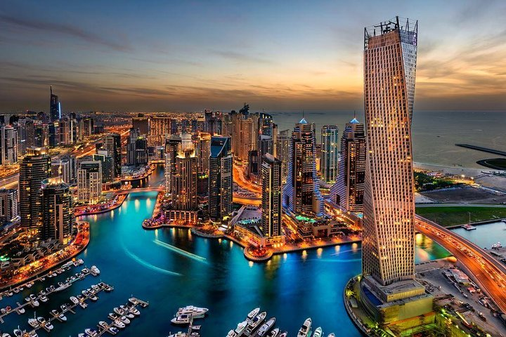 Explore Dubai's iconic skyline at sunset where modern architecture meets the shimmering waters inviting travelers to discover the city's unique blend of tradition and innovation.
